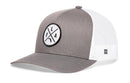 The Haka Hat Florida Trucker Hat features a gray and white design, mesh back, and a round front patch with black letters and symbols in an “FLA X” cross pattern.