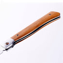 A close-up of the Messermeister Folding Steak Knife, part of the 4-piece set in a leather roll, with a wooden handle featuring two metal rivets and metal accents. The partially opened blade is shown against a white background.
