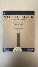 Brown box labeled “The Immaculate Beard Safety Razor,” featuring premium platinum-coated stainless steel blades. Simple razor image in the center depicts a sleek black metal safety razor design. Text appears in four languages. Bottom displays “10 pcs included” and indicates color as Black. Ideal for use with safety razor blades.