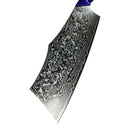 A close-up of the Spaceman Knives Gravity Series Nakiri blade showcases its intricate, wavy Damascus pattern and artistic layered design, with a slightly angled edge and part of its blue handle from Spaceman Knives visible.