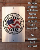 Metal sign with 'Made in the USA' design on a wooden background