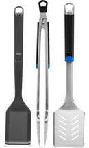 The Napoleon Grills 3-Piece Starter Tool Set Essential Series (GATL002) stands upright, featuring a grill brush, tongs, and slotted spatula against a white background.