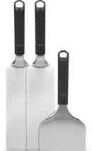 The Napoleon Griddle Starter 3-Piece Set for Griddles (GATL012) by Napoleon Grills includes three stainless steel spatulas: two long, rectangular ones and one shorter, wider spatula—perfect griddle tools for any beginner.