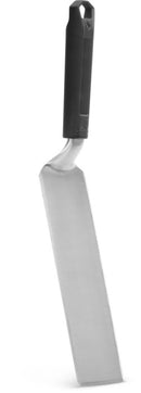 The Napoleon Grills Griddle Spatula (GATL014) features a long, rectangular stainless steel blade with a slight angle and heat-resistant handle, ideal for lifting or flipping foods like fish or pastries on griddles.