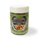 A jar of SALTOPIA Infused Sea Salts' Garden Herbs & Lemon Seasoning with a green label, a white plastic lid, and an image of seasoned food.
