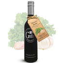 A dark glass bottle labeled Georgetown Olive Oil Co. and featuring a tan tag that reads Cilantro Garlic White Balsamic Vinegar is displayed in front of fresh cilantro leaves and garlic bulbs, highlighting the Georgetown Olive Oil Co Cilantro Garlic White Balsamic Vinegar—an aged white balsamic crafted in Modena, Italy.