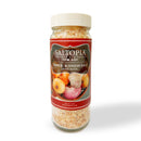 A clear jar with a cream lid labeled SALTOPIA Infused Sea Salts, ROOT MATES Garlic & Onion Salt, features onions and garlic images. The coarse, beige gourmet seasoning is perfect for elevating your favorite dishes.