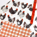 The Gingiber Chicken Apron by Gingiber features a cotton design with black and orange hens, a red and white checkered pocket, and an orange neck strap.