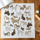 The Gingiber Dog Tea Towel by Gingiber features playful, stylized dog breeds in brown and gray on flour sack cotton—a charming accent for kitchen cleanup alongside your breakfast essentials.