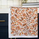 The Gingiber Mushroom Medley Tea Towel by Gingiber features a lively autumn design of orange, brown, and rust mushrooms and foliage—ideal for sourdough proofing or everyday kitchen tasks.