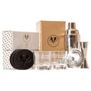 A Swanky Badger Whiskey Essentials Bundle including two personalized whiskey glasses, four leather coasters, a cocktail shaker, a jigger, and a strainer, displayed with their branded boxes.