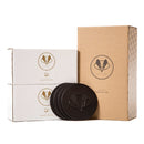 A Swanky Badger Whiskey Essentials Bundle featuring two stacked boxes of personalized whiskey glasses, a tall box labeled 3-piece cocktail set, and three round leather coasters.