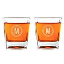Two personalized Whiskey Glasses: Medalist filled with amber liquid, each engraved with a letter M inside a circular border.