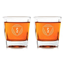 Two Swanky Badger Whiskey Glasses: Modern with square bottoms, each filled with amber liquid and featuring a triangular logo with the letter S.