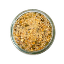A top-down view of a glass jar filled with SALTOPIA Infused Sea Salts’ Parmesan Black Truffle Seasoning: GODFATHER, a blend of dried herbs, seeds, and spices in yellow, green, and brown—ideal as a cheese seasoning for popcorn—set on a white background.