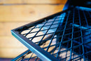 Two metal grill grates with a diamond-pattern mesh, positioned one above the other as a Pimp My Grill® Gen2 Slide-Out Rack System for the Traeger Ironwood 885.