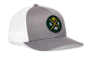 The Haka Hat Green Bay Trucker Hat features a gray and white design with a round green patch showing crossed yellow bats, cheese, football, and "GB" letters. This snapback blends sporty flair with classic mesh comfort.
