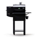 The Green Mountain Grills Trek Cart 2.0, a black pellet grill and smoker with a side hopper, digital controls, vent chimney, front shelf, and bottom bucket, is displayed on wheels against a white background for a sleek appearance.