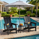 Two black DirectDeals Adirondack Chair with Cup Holder - HDPE Outdoor Seating stand poolside with drinks, facing a small table of fruit under a large gray umbrella, palm trees, and a house in the background.