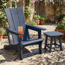The DirectDeals Adirondack Chair with Cup Holder - HDPE Outdoor Seating sits beside a matching table on a stone patio, surrounded by potted plants and blooming flowers.