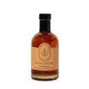 Under The Bark Syrup Co Habanero Maple Syrup comes in an 8.4 fl oz (250ml) glass bottle with a black cap and beige label featuring a maple leaf logo—made in Minnesota, it adds sweet heat to your dishes.