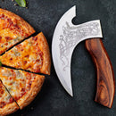 A pizza with three slices cut sits next to the Texan Knives Viking Axe Pizza Cutter – Hand Engraved 8-Inch J2 Steel Blade, featuring a wooden handle and intricate blade designs, displayed on a dark surface.