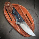 The Texan Knives Texas Knives Handcrafted Western Cutlery Knife features an 8" patterned steel blade, a mixed wood-and-resin handle, and comes with a tooled leather sheath with white stitching, displayed on a dark surface.