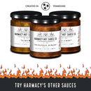 Three Harmacy Hot Sauce Co. bottles, including Totec’s Teeth Extra Hot Pasilla & Plum Sauce 9oz, are displayed with a Tennessee emblem above and flames below. The text reads, “Try Harmacy’s Other Sauces.” Super-hot varieties take center stage.