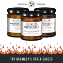 Three jars of Harmacy Hot Sauce Co. sauces—including Chi-Chee Kimchi Sauce 9oz—sit above fiery graphics and “TRY HARMACY’S OTHER SAUCES” text, with “Created in Tennessee” and a star emblem overhead.