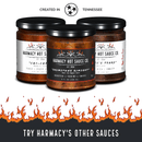 Three jars of Harmacy Hot Sauce Co., including Pata del Diablo Extra Hot Tomatillo & Clementine Sauce 9oz, Chili Head, and Grimstone Rimshot, are displayed with flames. Text: “Created in Tennessee” and “Try Harmacy’s Other Sauces.”.