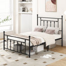 A black metal bed frame stands in a bright room. Underneath, the DirectDeals 3-Height Folding Camping Table with Large Storage Net & Handle provides extra storage alongside boxes, while shelves, books, and decor complete the space.
