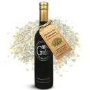 A dark bottle of Georgetown Olive Oil Co. HERBES De PROVENCE High Polyphenols Extra Virgin Olive Oil, featuring a gold cap and a white label with the Georgetown Olive Oil Co. logo, is displayed with a tag in front of a pile of dried herb mix.