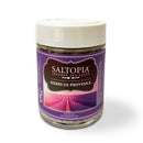 A glass jar of SALTOPIA Infused Sea Salts' Saltopia Herbs De Provence Seasoning Salt features a white lid and a purple label with a lavender field image, made using Pink Himalayan Sea Salt.