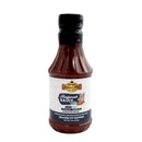 A bottle from Hickman's BBQ Mild Rub and Sauce Package with a dark cap and pig label. This Kansas City-style sauce is gluten-free—ideal for serious BBQ lovers who enjoy classic rub and sauce pairings.