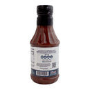 A bottle of Hickman's BBQ Haugwaush Gluten Free Natural BBQ Sauce (19 oz, pack of 2) is shown from the back, featuring a black cap and a label displaying ingredients, nutritional information, barcode, and usage instructions. The sauce from Hickman's BBQ is gluten free and labeled as mild heat.