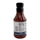 A bottle of Hickman's BBQ Haugwaush Gluten Free Natural BBQ Sauce 19 oz by Hickman's BBQ, shown from the back to display its nutrition facts and ingredients label. The plastic bottle features a black cap and is filled with maroon-colored sauce.