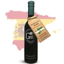 A bottle of Georgetown Olive Oil Co. Hojiblanca (SPAIN) Extra Virgin Olive Oil, featuring the Georgetown Olive Oil Co. brand, stands before a faded map and flag of Spain. The bottle displays a dark label and green cap, with a Washington, DC address at the bottom, emphasizing its authentic Spanish origin.