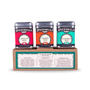 Three Spicewalla tins—Apple Pie Spice, Pumpkin Spice, and Gingerbread Spice—are displayed atop a brown box labeled “Spicewalla 3 Pack Holiday Baking Collection,” featuring enticing descriptions of Gingerbread Spice and the other festive blends on the front.