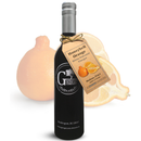 A dark glass bottle of Georgetown Olive Oil Co. Honeybell Orange White Balsamic, crafted in Modena, Italy, with a tan tag, is displayed in front of a whole and sliced orange citrus fruit on a white background. This aromatic aged white balsamic from Georgetown Olive Oil Co. captures the vibrant essence of Honeybell oranges for a unique culinary experience.