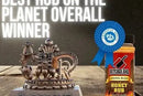 A metal crown trophy, a blue winners ribbon, and a bottle of Butcher BBQ Honey Rub "The Original" Dry Rub / BBQ Seasoning / Spice by Butcher BBQ are displayed. Text above reads, Best rub on the planet overall winner.