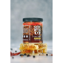A jar of Spice Witch Chili Oil + Chili Crisp by Spice Witch sits on a surface with honeycomb pieces and peppercorns. The label features bold, spicy oil crafted with avocado oil and chili crisp for flavorful heat.