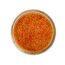 A glass jar of SALTOPIA Infused Sea Salts' Saltopia Habañero Salt: HOT HEAD, featuring a coarse orange-red seasoning blend, viewed from above against a white background.