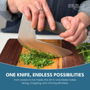 A person chops fresh herbs on a wooden cutting board using the large, uniquely shaped NULU Knife from NULU Inc.’s Knife and Dock Bundle, with text in the lower half of the image highlighting the versatile and ergonomic design of this kitchen essential.