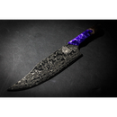 The Spaceman Knives Gravity Series Chef Knife by Spaceman Knives, with a striking Damascus blade and purple marbled handle, rests on a dark surface and is dramatically lit from the left.
