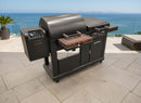 A BBQ Boards® Blackstone Pellet Grill Combo Front or Side Cutting Board creates the perfect prep station with digital controls on a tiled patio, overlooking the ocean on a clear day.