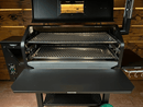 An open pellet grill featuring the Green Mountain Grills Peak / Jim Bowie | Pimp My Grill® Gen2 Slide-Out Rack System with two tiers installed inside the cooking chamber to maximize space.