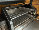 Two-tiered Pimp My Grill® Gen2 Slide-Out Rack System - 2 Racks for Green Mountain Grills Ledge / Daniel Boone inside an open pellet smoker, featuring a dual-level cooking system.