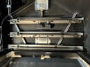 Interior of a pellet grill featuring a Pimp My Grill® Gen2 Slide-Out Rack System with two stacked, horizontal metal slide-out racks installed inside the chamber.