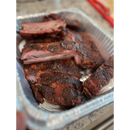 Sliced rack of sweet and smoky BuffalowBBQ Sassy Swine BBQ Rub ribs in an aluminum foil tray.