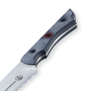 Close-up of the Messermeister Iron & Resin Overland Chef 8″ Bread Knife handle, featuring a dark, textured grip with distinctive red and black rivets, and showcasing part of the scalloped stainless steel blade with the Messermeister logo engraved—set against a white background, perfect for outdoor cooking.